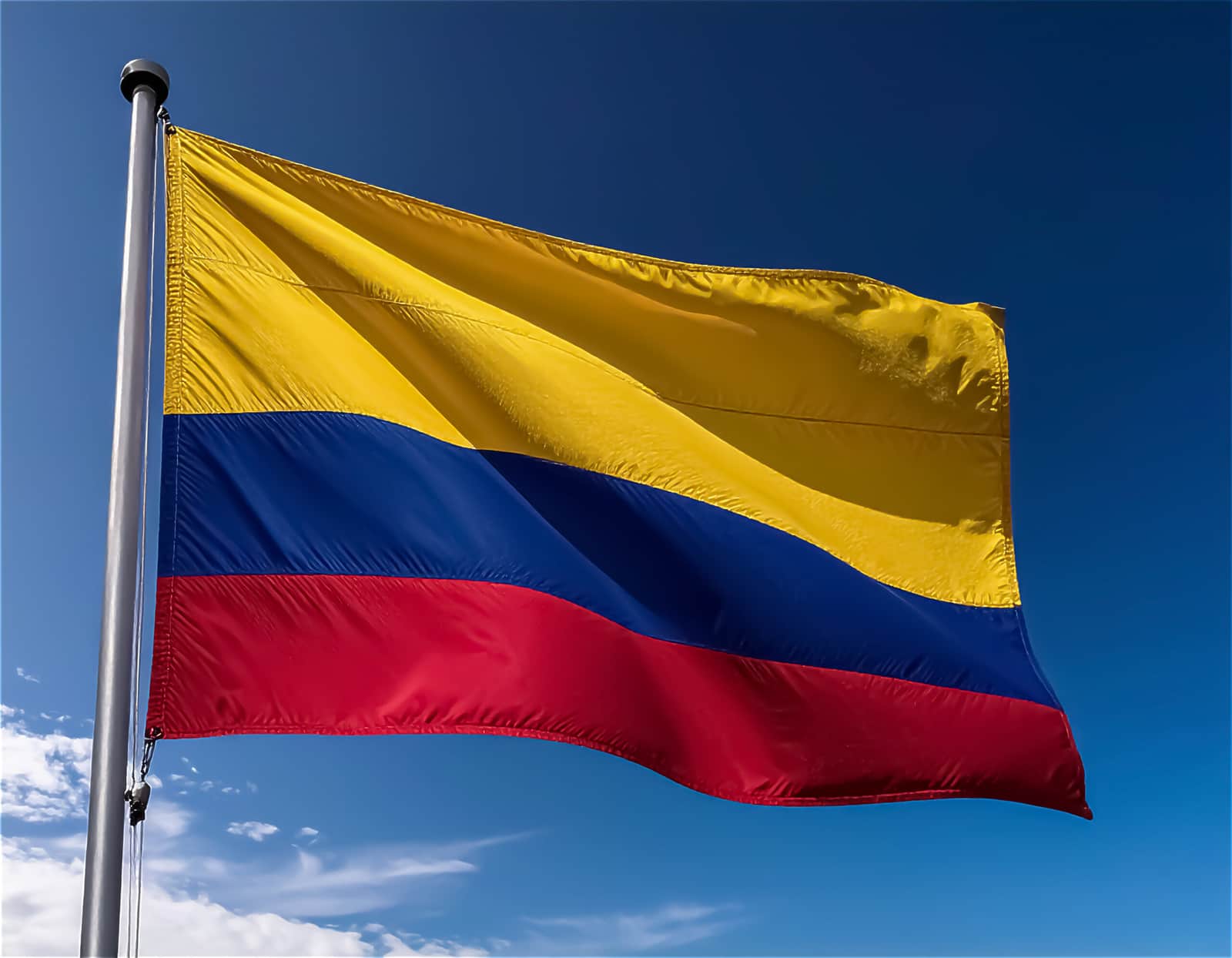 Colombia flag waving in the blue sky